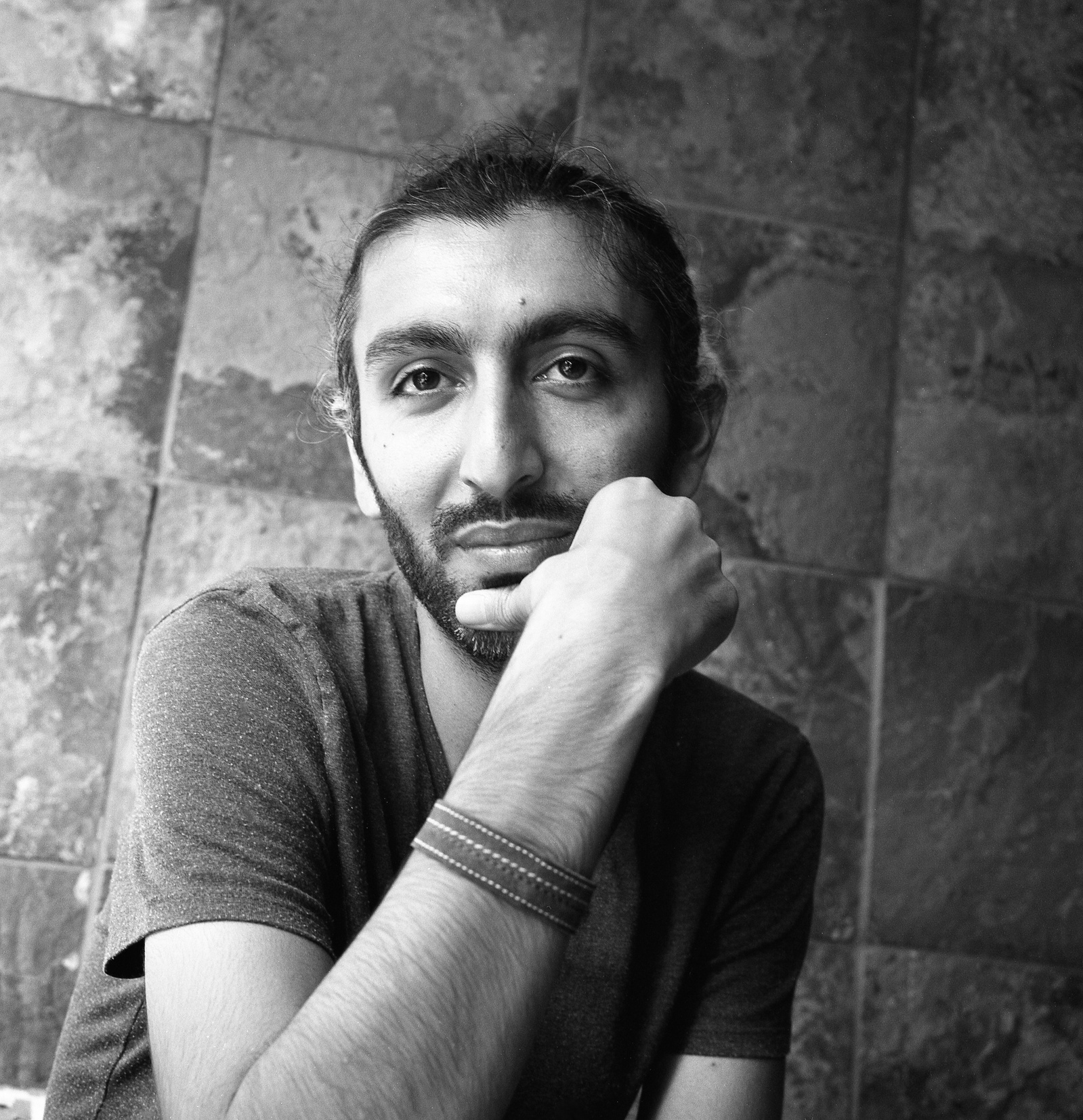 Black and white portrait of a young Iranian man.