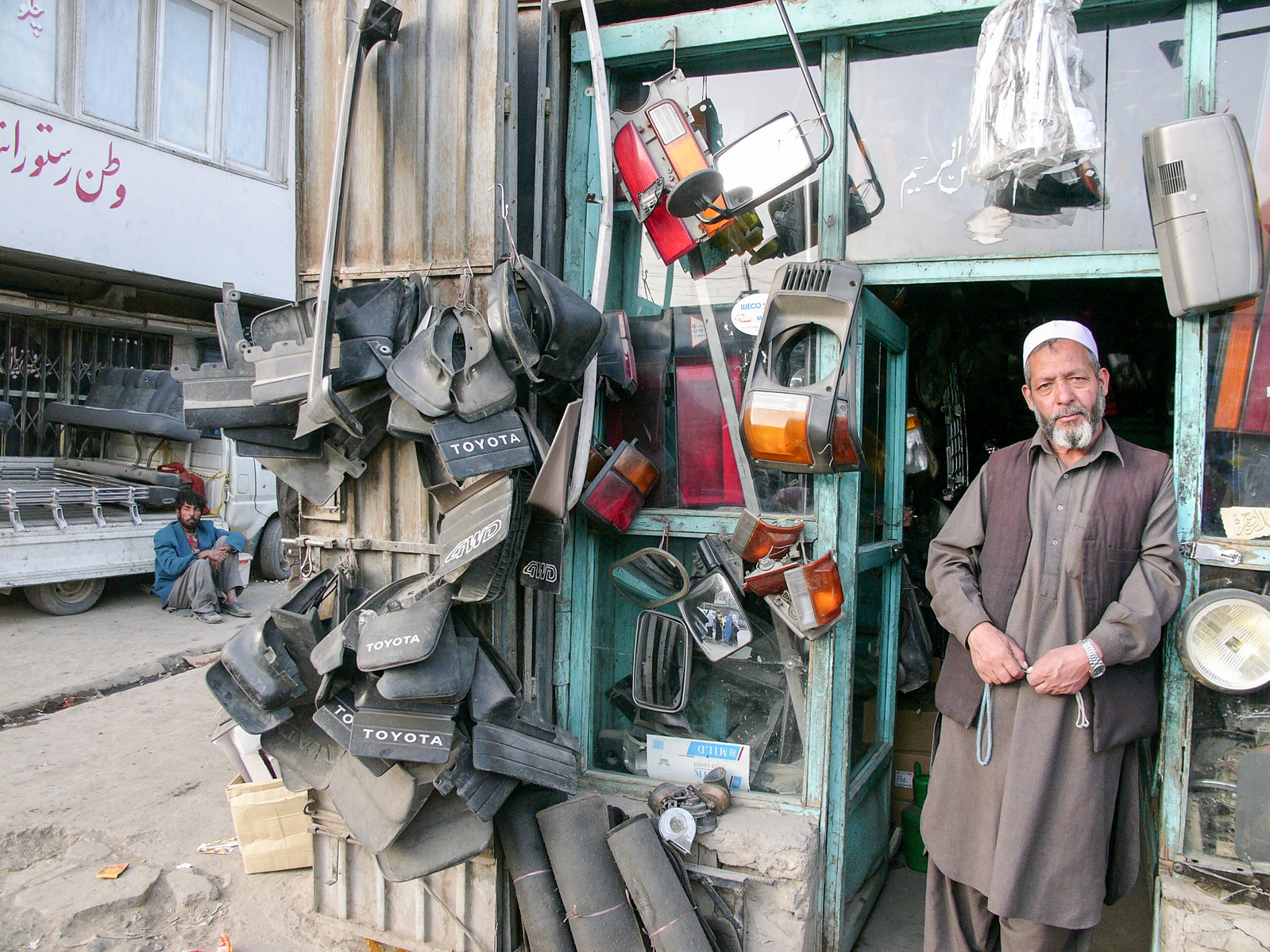 A man standing in the doorway of a car spare part shop in Kabul, Afghanistan.