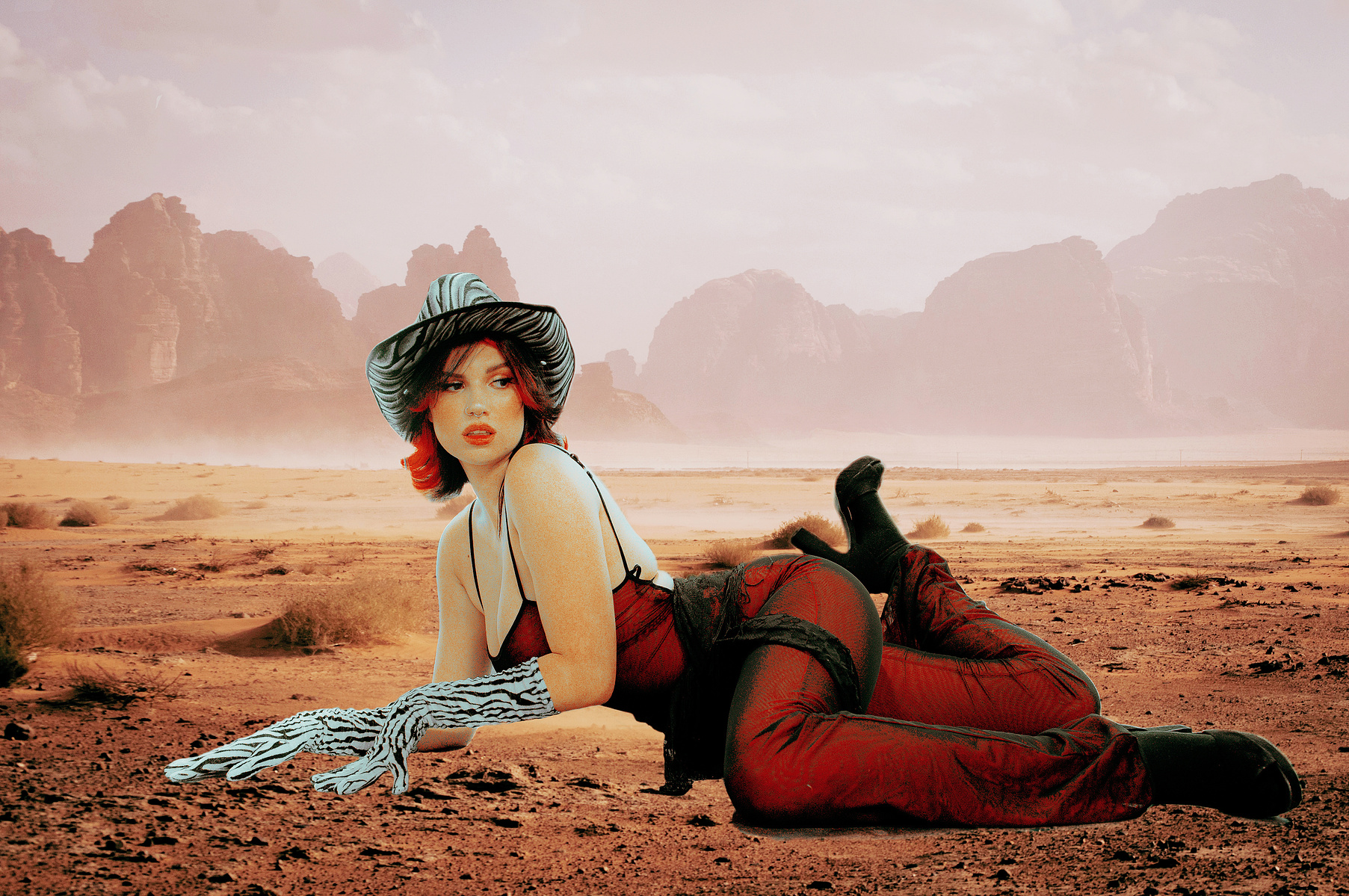 Girl in cowboy hat in desert