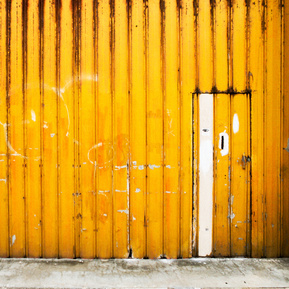 A warehouse door painted in bright yellow, Fremantle, Western Australia.