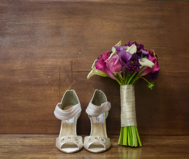 Flowers and shoes of the bridal details at the historic ocurthouse microwedding of an african american couple
