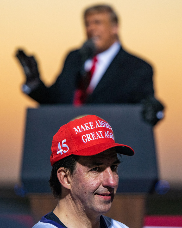 A supporter of the President turns around to have a photo taken of him with President Trump during a rally in Rochester, Minn. on Friday, Oct. 30, 2020.
