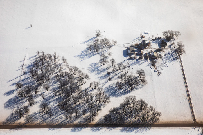 A farm near Maple Ridge, Minn., is seen from 2,700 feet from a NOAA plane measuring snow pack on Thursday, Feb. 13, 2020. A camera mounted to one of plane's rear windows take snapshots as snow data is collected, giving scientists an image to reference wit