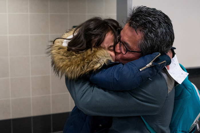 Yulin Yin embraces his six-year-old daughter Emy after arriving at Minneapolis-St. Paul International Airport on Wednesday, Feb. 19, 2020. Yin was visiting family in Wuhan, China when the COVID-19 outbreak occured.