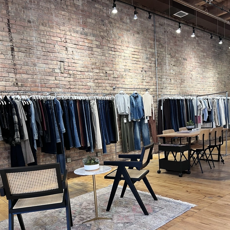 Clothing showroom with brick walls and high ceilings.