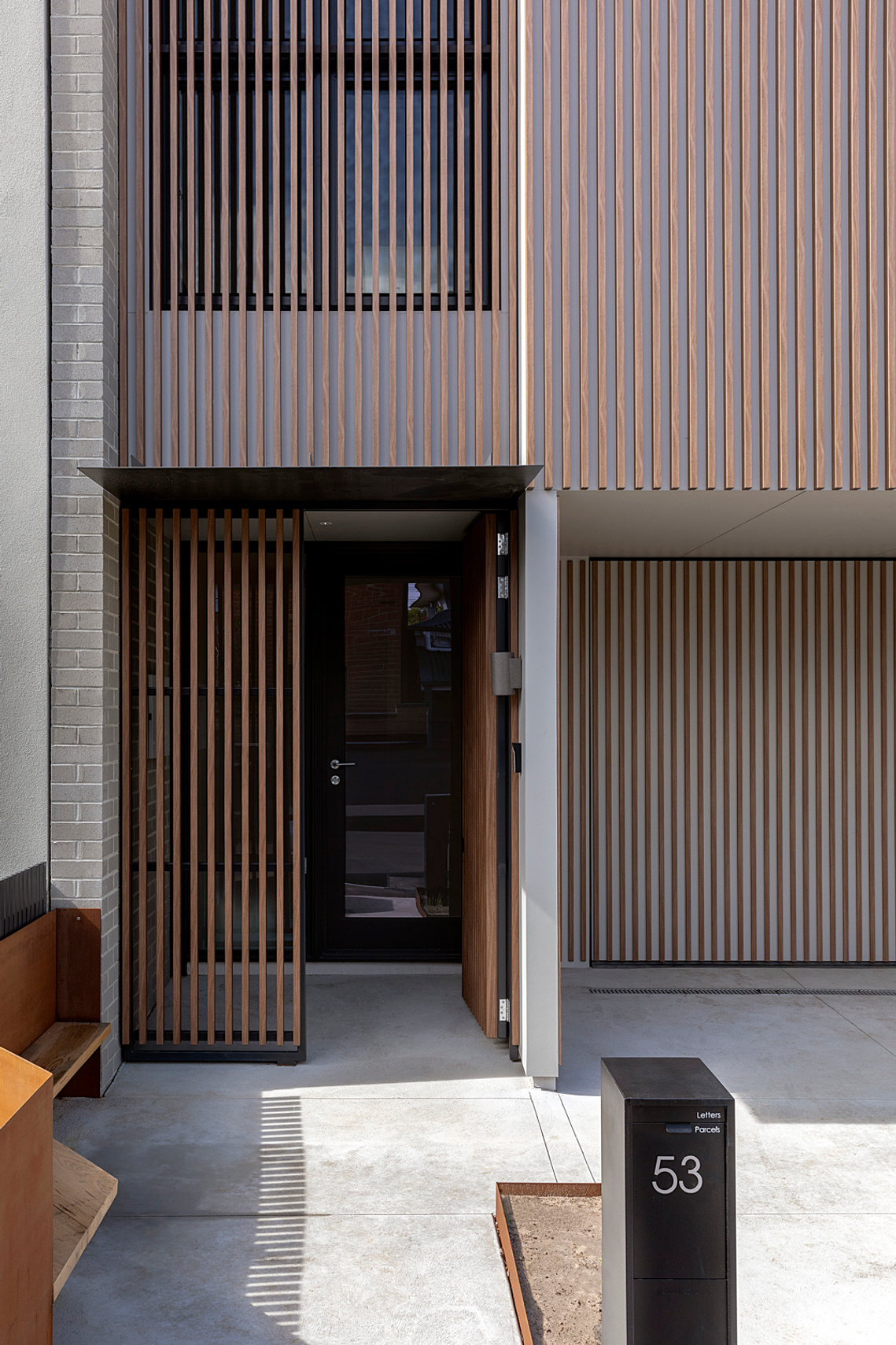 New house with timber battens and open front door