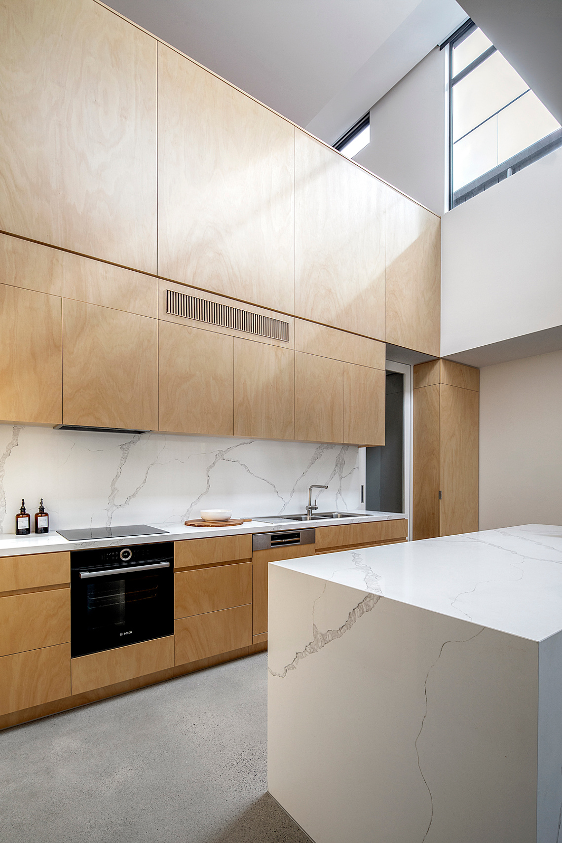 New double height kitchen space, with kitchen made of plywood