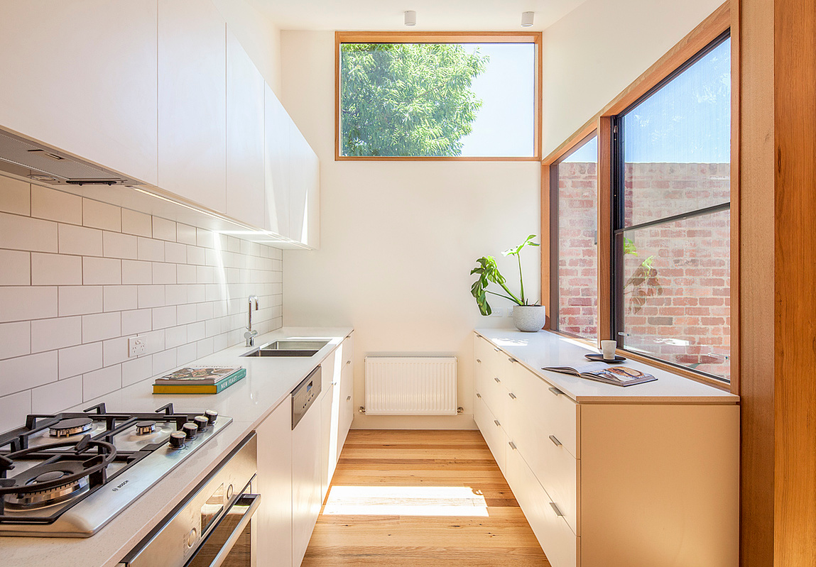 The new kitchen is flooded with light from a central courtyard and overhead. Sky views add to the sense of expanse in the house