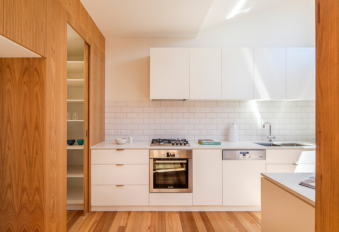 The new kitchen is flooded with light from a central courtyard and overhead. Sky views add to the sense of expanse in the house