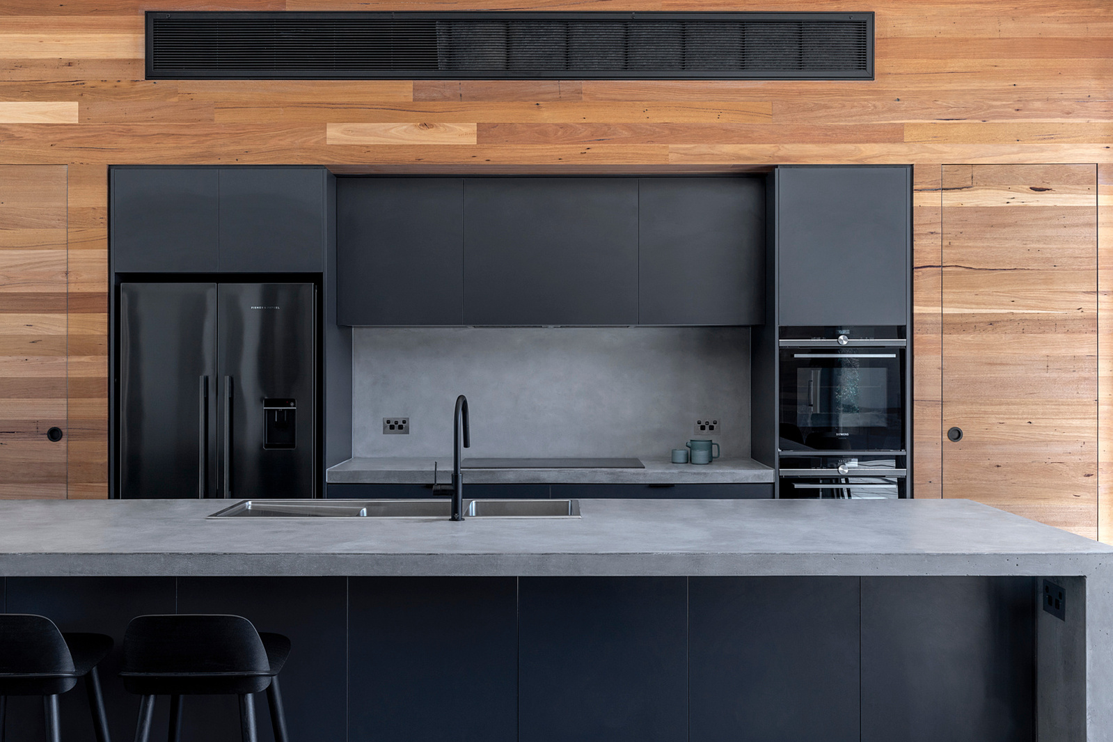 Modern kitchen design with recycled re-milled timber lining boards and feature concrete bench-tops