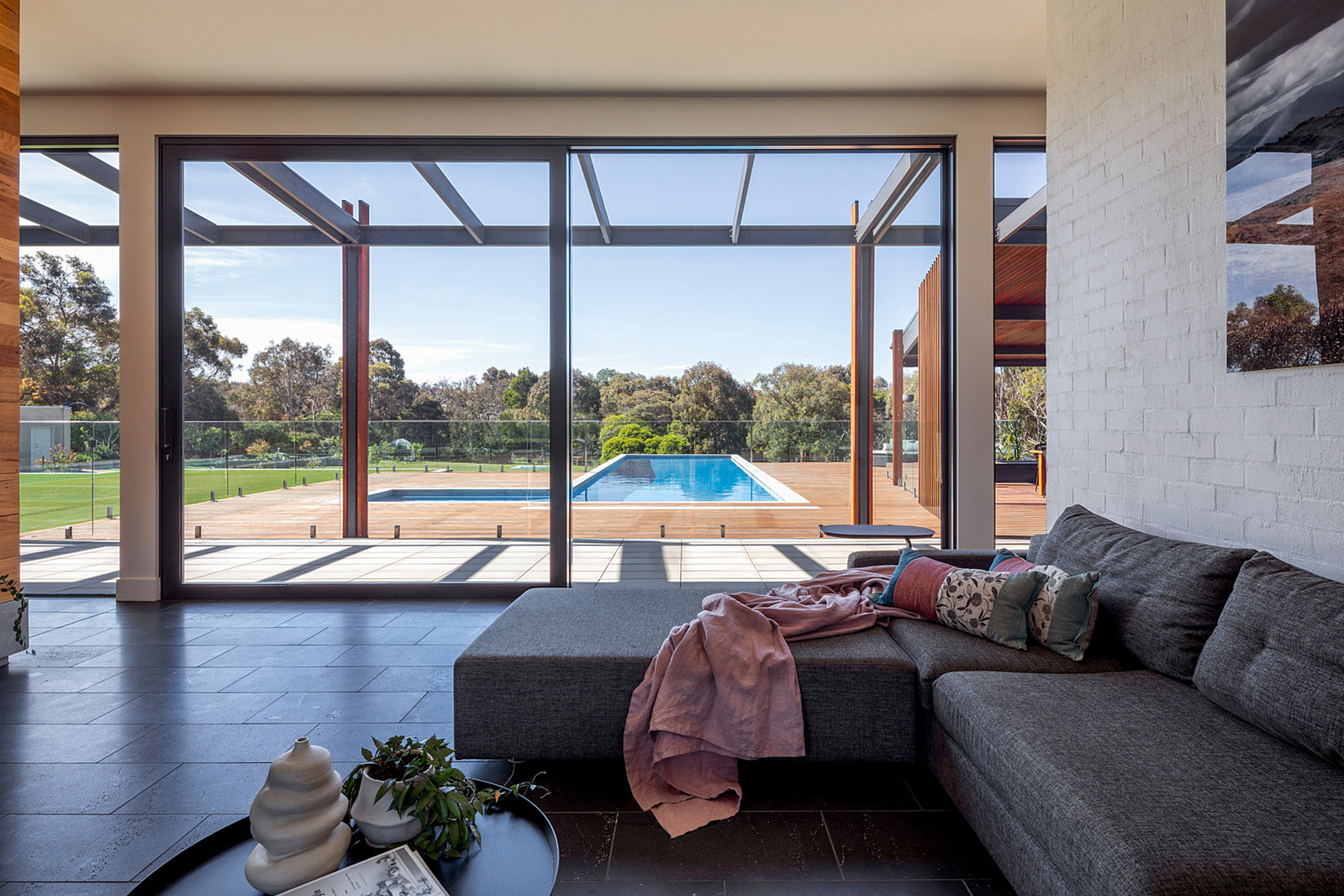 A relaxed north facing living area with outlook onto an inviting swimming pool