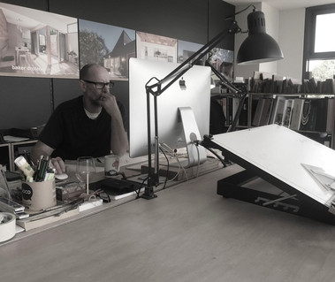Paul Baker Architect at his desk in the office located in Torquay