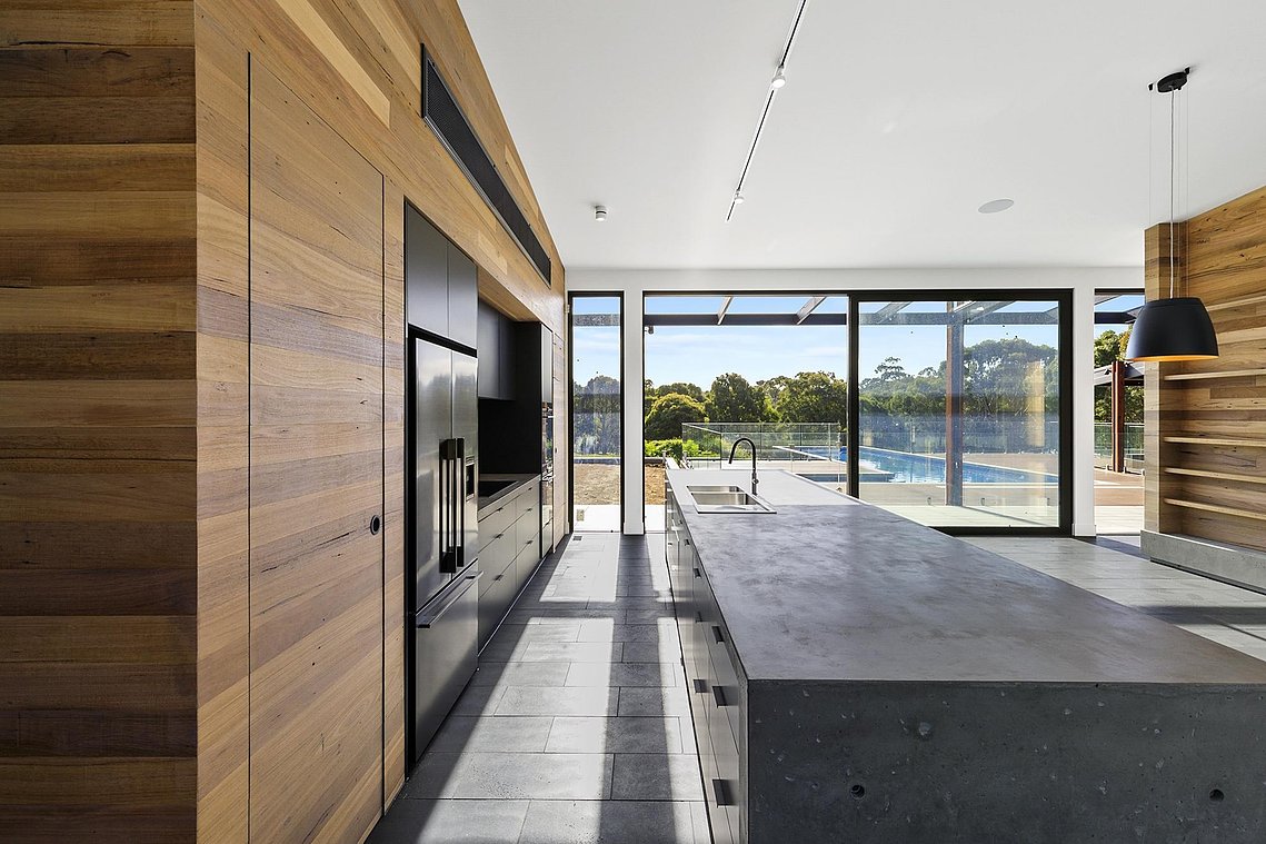 New sustainable house design Torquay. Kitchen dining space outlook onto large pool