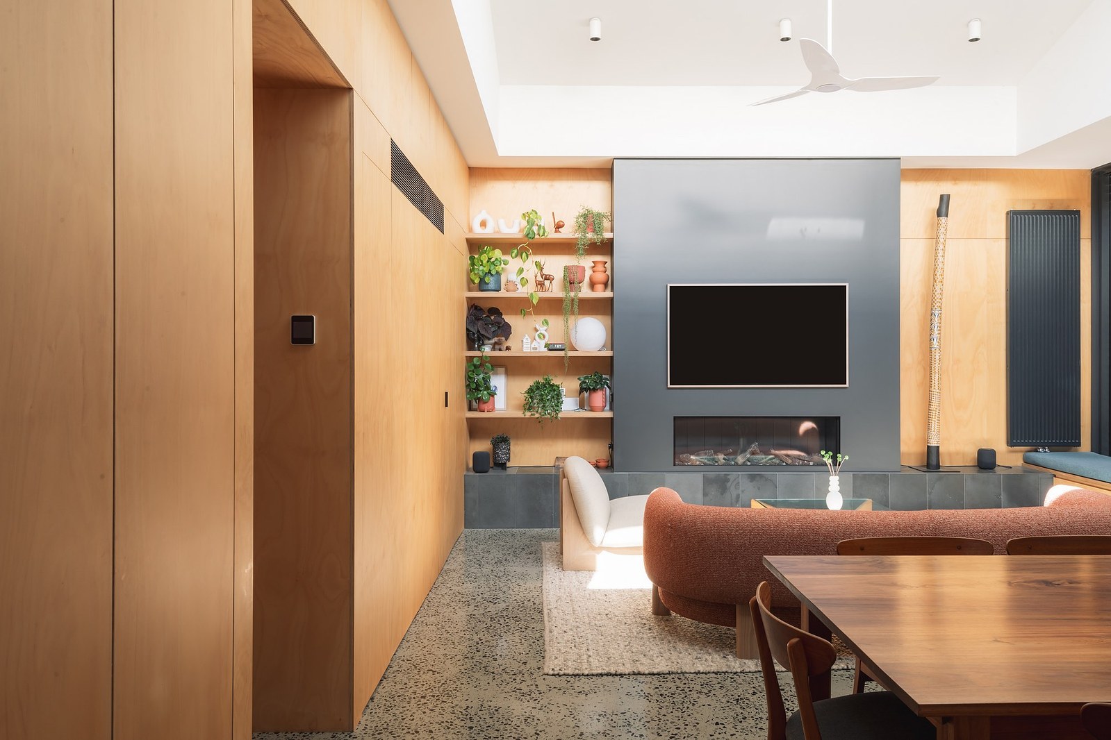 Ply lined walls with fireplace and TV on far wall