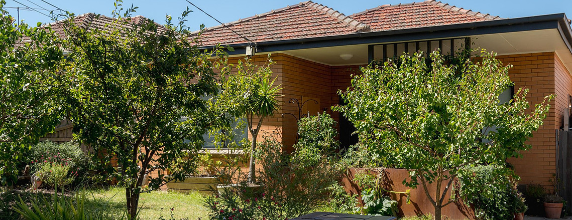 Existing brick veneer home front garden and front facade with new green screen. Sustainable building ideas Preston