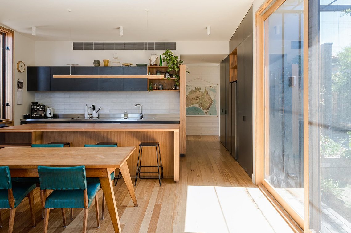 Overview of kitchen dining living space with sun streaming through the north facing windows. Sustainable living Preston