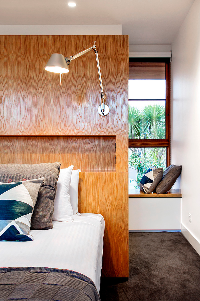 A bed wall provides storage on both sides