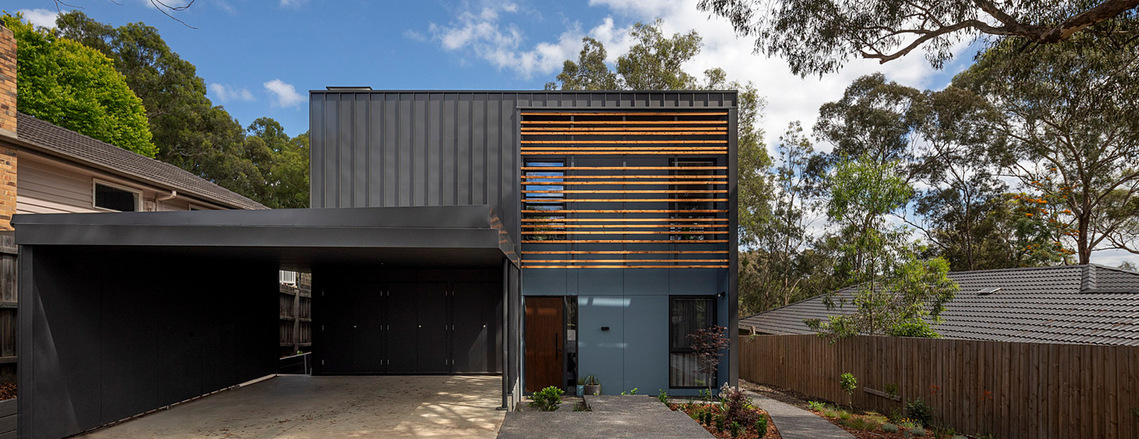 This all electric high efficiency house has a contemporary facade to the street