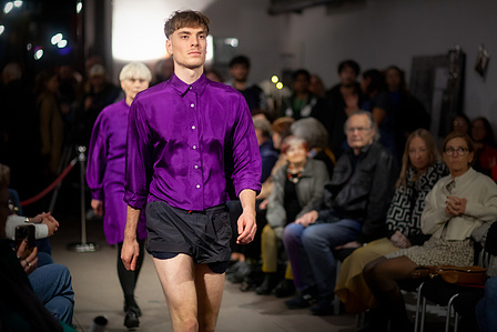 Male model on runway wearing a purple silk shirt by Marlena Frank
