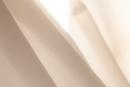 Soft fabric, white silk, high key, abstract. Straight lines formed by a silk shirt against the light