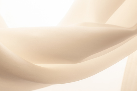 ​Soft fabric, white silk, high key. Arm of a silk shirt against the light