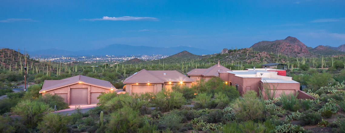 Twilight view of an expansive estate in Tucson AZ with city lights view.  