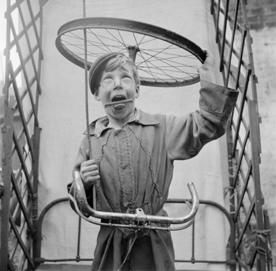 Image: Boy with a bicycle wheel (c) Estate of Nigel Henderson.  Licensed: Creative Commons CC-BY-NC-ND.  Source: Tate