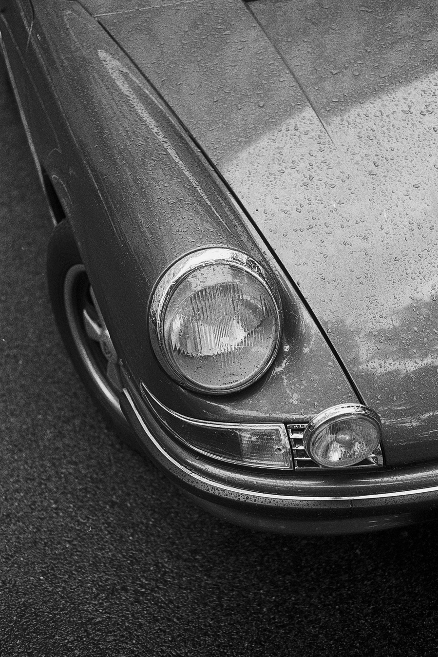 Black and white photograph of a classic Porsche headlight