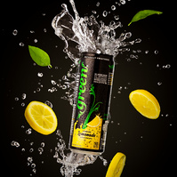 Image of Green Soda Sparkling Lemonade with water and fruit splashing around it suspended in air photographed by commercial photographer Jason Barnes