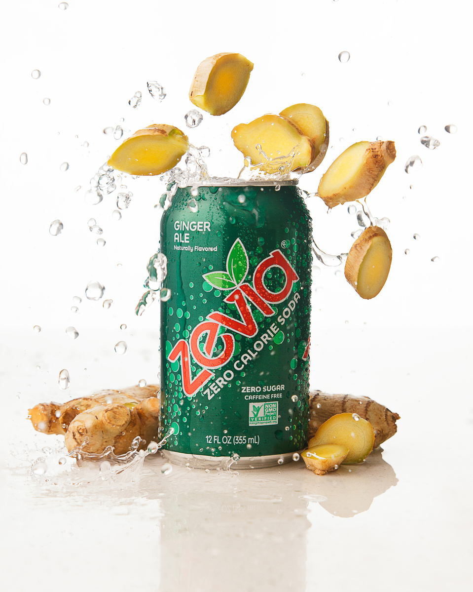 Image of Zevia Ginger Ale Zero Calorie Soda with real ginger and splashing liquid in dynamic composition photographed by commercial photographer Jason Barnes