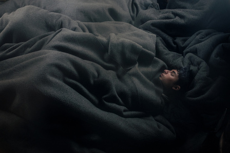 Young Afghans migrants sleep in an abandoned train wagon in Belgrade station. (Serbia 2017)