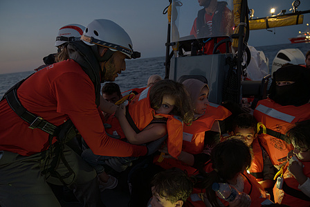 Emergency's Search and Rescue (SAR) crew rescuing a distressed boat with 76 people, including women and children, in the Mediterranean off the Libyan coast. 