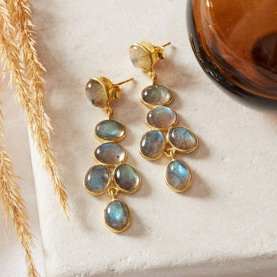 NOTHS jewellery photography uk, boho gold gemstone earrings on a linen background with dried flowers