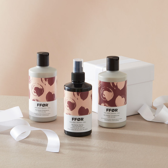 Christmas product photography, haircare bottles with white ribbon and wrapped gift box