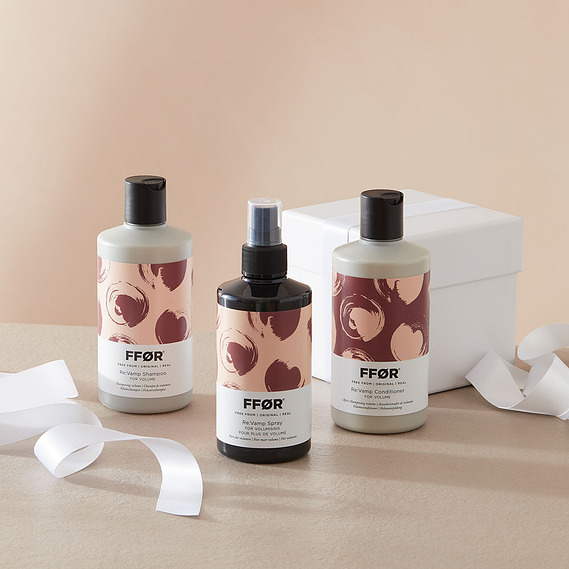Christmas product photography, haircare bottles with white ribbon and wrapped gift box