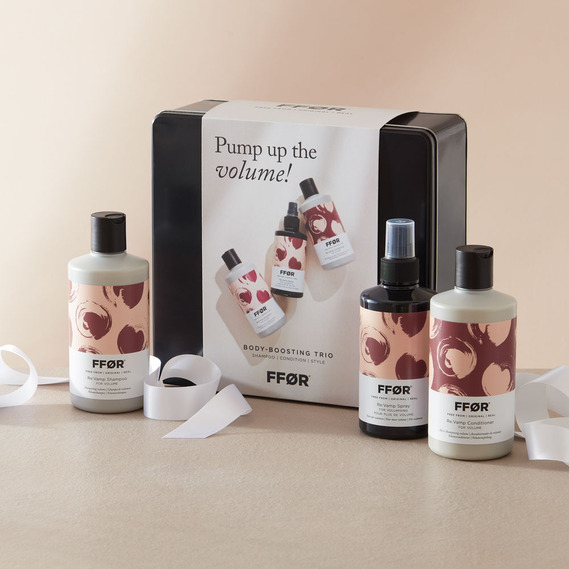 Christmas product photography, haircare gift set with a white gift ribbon on a neutral background