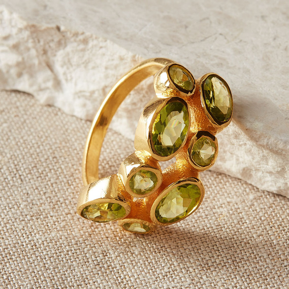 noths jewellery photography uk, a boho gemstone ring on a rough stone background