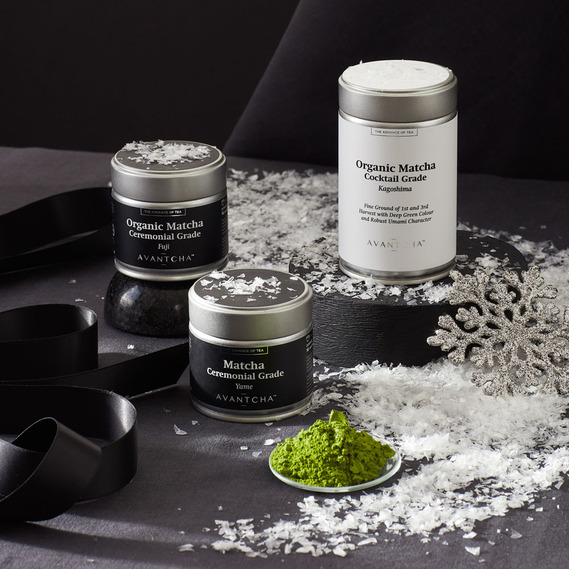 Christmas food photography, tea caddies with fake snow on a black background