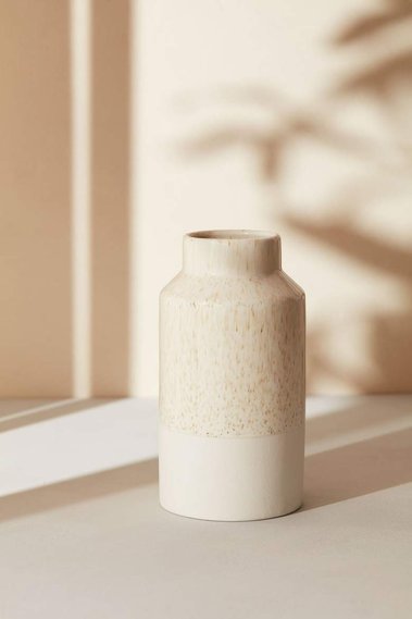 Product photography of a ceramic vase in dappelled light and shadow