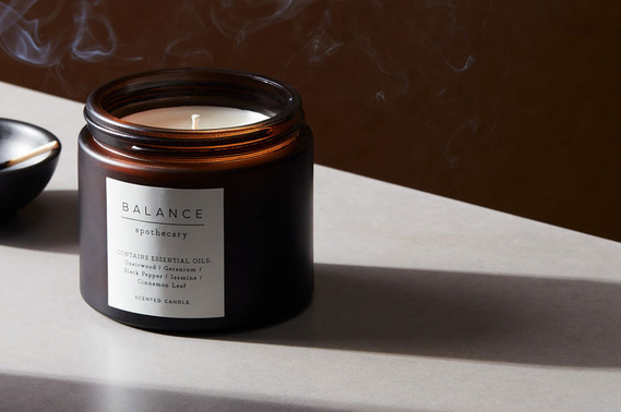  A candle with smoke and hard shadows, lifestyle product photography.