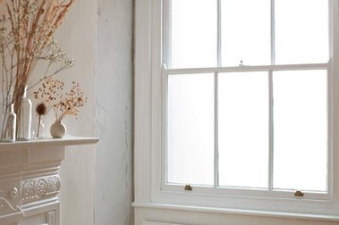 Product photography studio Hastings, with period features. Whitewashed Edwardian fireplace shelf with dried flowers and sash window