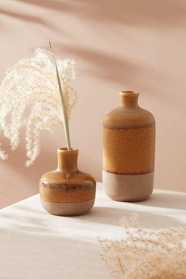 Homeware product photography of two brown ceramic vases with dried flowers.