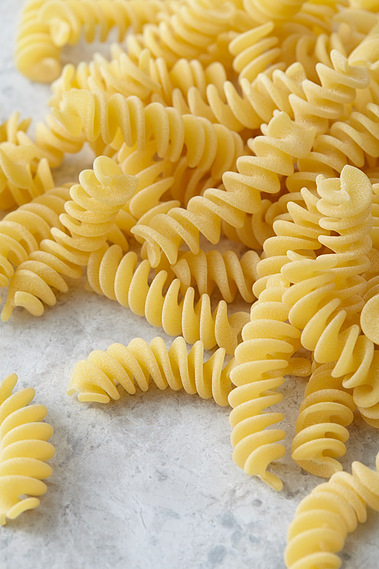 Pasta twirls on a stone background
