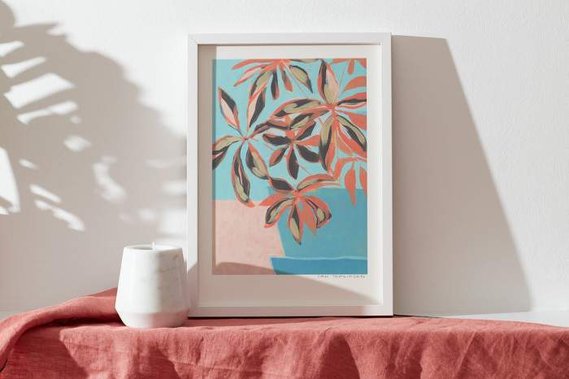 Product photography of floral artwork in a frame on a mantlepiece
