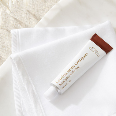 Beauty product photography for a brow dye on a white textured background