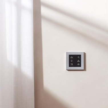 Homeware product photography of Focus SB designer light switches on a neutral colour wall with white linen  curtains with shadows from the window