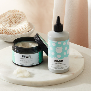 Haircare product photography. A group shot of scalp treatments in a lifestyle setting on a marble tray