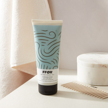 Haircare product photography, FFOR bottle in a bathroom set with a towel and comb