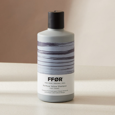Haircare product photography, shampoo bottle in hard shadows on a neutral background