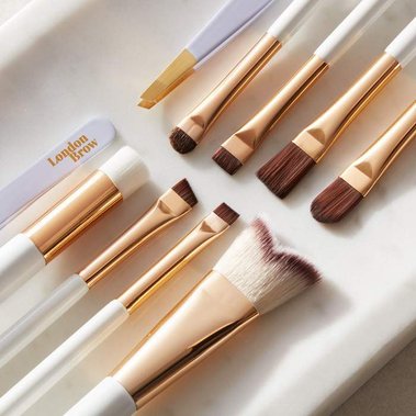 Cosmetics product photography, make up brushes on a white marble tray